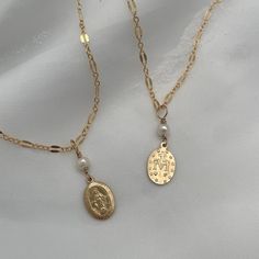 Our Miraculous Medal Dainty Necklace is a beautiful reminder of faith and the power of prayer. This beautiful necklace features a hand-wired accent stone of your choice on a delicately accented chain. 9mm x 13mm Miraculous Medal charm in sterling silver or 14kt gold fill hand-wired pearl or pyrite charm accent sterling silver or 14kt gold fill chain for long-term worry-free wear Our handmade pieces are made with care, orders ship within 5 to 10 business days