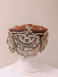 Handmade Afghan Halima Sultan Cap Head Jewelry Mathapatti ALERT!! Heavy Cap, heavily embellished A beautiful handmade afghan head jewelry is here. The afghan artisans residing in Pakistan make these beautiful caps. These are beautiful and one of a kind. There are vintage embellishments attached and beautiful hangings attached to the front. The cap covers the forehead, but it varies from person to person. This goes well with traditional afghan dresses and jewelry.  In addition, these can be perfe Bohemian Adjustable Headpiece With Round Crown, Traditional Handmade Headband, Traditional Multicolor Beaded Hat, Bohemian Silver Hat For Festivals, Bohemian Multicolor Wedding Headpiece, Silver Bohemian Hat For Festival, Bohemian Handmade Headpiece With Round Crown, Multicolor Bohemian Hat With Bead Caps, Handmade Bohemian Headpieces With Round Crown