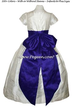 a white and purple dress with blue sash