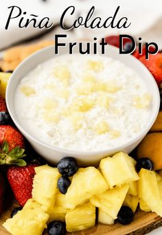 fruit dip with pineapples, strawberries and blueberries on a platter