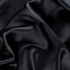 Presenting a quality Premium Black Stretch Silk Charmeuse made especially for Mood. Medium weight with an exquisite drape, this lustrous material is made that much more versatile given its added crosswise stretch. The ideal fabric for classic gowns, dresses, blouses and lingerie, silk charmeuse can also be used for superior linings. Available in 95+ attractive shades. 

Note: Dye lots are subject to change up to 10% in either direction. Ordering swatches is HIGHLY recommended for these products. Tux Dress, Bed Hair, Silk Bedding Set, Silk Sheets, Silk Sleep Mask, Silk Set, Silk Bedding, Mood Fabrics, Luxury Silk