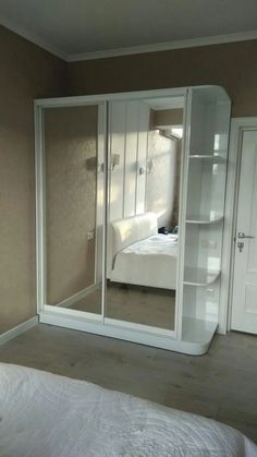 a bedroom with a bed and closets in it