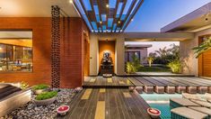 the inside of a house that has a pool and patio area with furniture in it