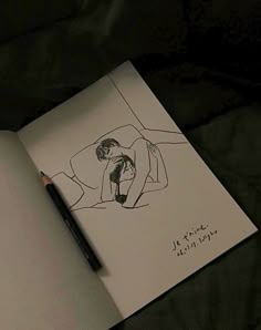 an open notebook with a drawing of a woman laying on her stomach and holding a pencil