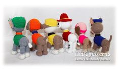 several crocheted stuffed dogs wearing hats and sweaters