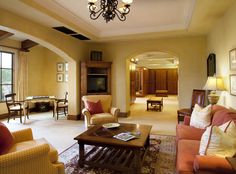 a living room filled with furniture and a chandelier