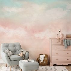 a chair and ottoman in front of a pink wall with clouds painted on the walls