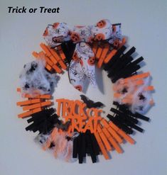 a halloween wreath made out of black and orange sticks