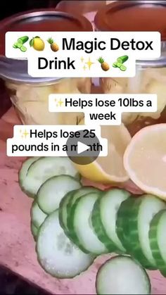 a pile of sliced cucumbers sitting on top of a cutting board next to a jar of liquid