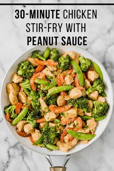 chicken stir fry with broccoli and carrots in a white bowl on a marble surface