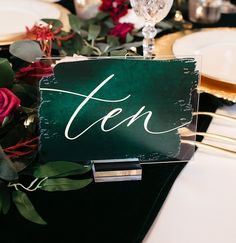 a table setting with place cards and silverware