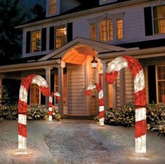 lighted candy canes in front of a house