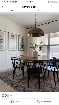 a dining room table with four chairs and a potted plant on top of it