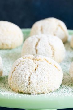 some sugary cookies are sitting on a green plate