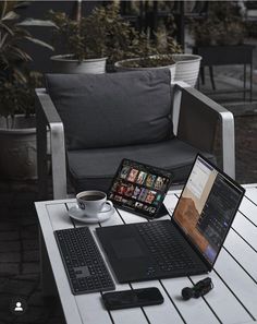 an open laptop computer sitting on top of a table next to a keyboard and mouse