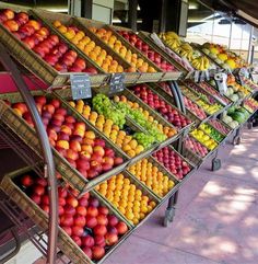 many different types of fruit are on display in the produce section of a grocery store