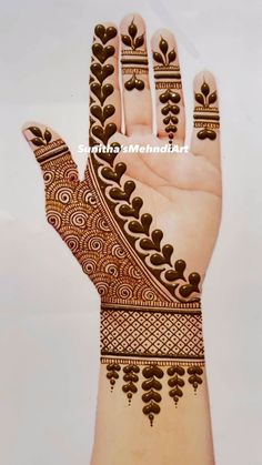 the hand is decorated with henna designs