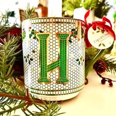 a decorated christmas mug with the letter l on it