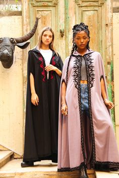 This hand embroidered cape is a bohemian dream. It's extremely classy and practical. Will definitely keep you warm on those winter nights while making you look like an African queen. Material : Wool Length : 49 inches Size : Free size - up to 3 XL We ship your order with DHL express within one to two business days. Orders to Europe will typically arrive within 2 to 3 business days and to USA within 3 to 5 business days from the date of shipping. **Please note that shipping to these locations in Embroidered Cape Outerwear For Fall, Bohemian Hooded Cape For Festivals, Bohemian Long Cape For Fall, Oversized Cape Outerwear For Festivals, One Size Bohemian Cape Outerwear, Bohemian One-size Cape Outerwear, Bohemian Hooded Cape One Size, Black Moroccan, Cape For Women