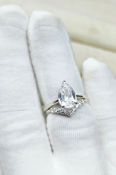 a close up of a person's hand with a ring on top of it