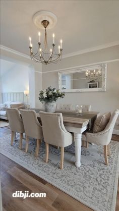 a dining room table with chairs and a chandelier