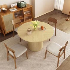 a dining room table with four chairs around it