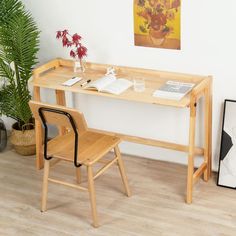 a wooden desk with a chair next to it and a painting on the wall behind it