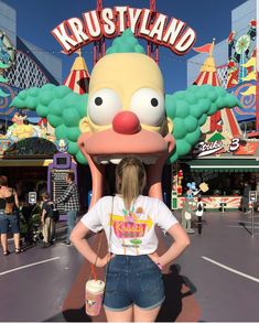 a woman standing in front of a cartoon character