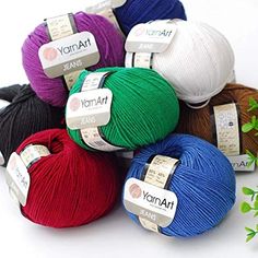 several balls of yarn with labels on them