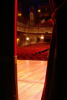 the cover of behind the scenes of christmas, with an image of a man standing in front of a stage