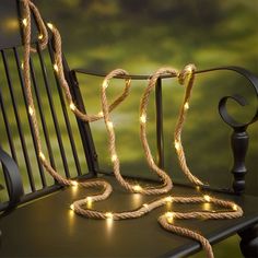 a bench that has some lights on it and rope wrapped around the back of it