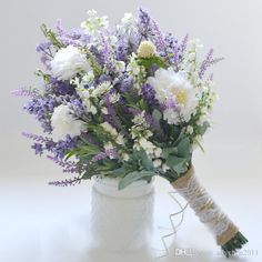 a bouquet of white and purple flowers in a vase with the words madda bell above it