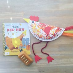 a red hen book and toy on a wooden table