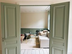 an open door leading to a living room filled with furniture