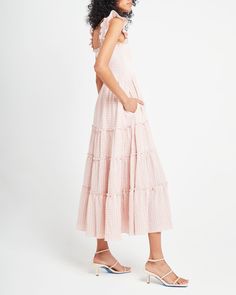 Pricing Comparison Few Moda $68 Reformation $278 For Love & Lemons $248 Product Details Adorable ruffled cap sleeves finish off the smocked bodice of this soft and breezy dress. Done with a tiered maxi skirt and side pockets.- Pockets- Square neckline- Maxi length- Content: 30% Cotton, 68% Polyesters, 2% Spandex- Care: Machine Wash Cold / Hand Wash Style# K21WDR10053 Fit Notes - Model wearing a size XS- Model measurements: 5'8.5'' Height / 30'' Bust / 23'' Waist / 33'' Hips- Garment measurem Gingham Midi Dress, Midi Dress Pink, Bra Size Charts, Tiered Maxi Skirt, Breezy Dress, Cap Dress, Pink Midi Dress, Gingham Print, Dress Shapes