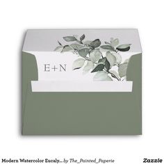 an envelope with the word e - n on it, and leaves painted on it