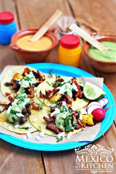 mexican food on a plate with sauces and condiments