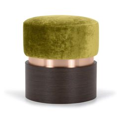 a green velvet stool with copper trim around the top and bottom, on a white background