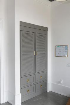 an empty room with two large gray cabinets