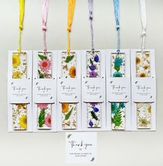 six flower seed packets hanging from strings with thank you tags attached to the back of them