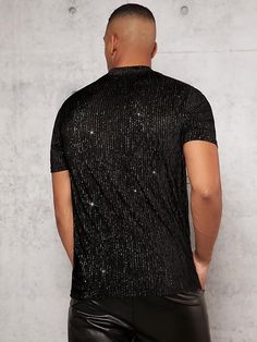 This Men's Black Mesh Crewneck Sequin Short Sleeve Shirt features lightweight mesh fabric and a shimmery sequin pattern for a unique and stylish look. The construction is breathable and comfortable, making it a great choice for warm-weather days. 100% Poly Imported Pull On closure Hand Wash Brand Size Chest Waist S 43.7 40.6 M 45.7 42.5 L 48.7 45.5 XL 51.7 48.5 XXL 54.6 51.5 Stretch Contrast Sequin Tops For Party Season, Fitted Black T-shirt For Party, Fitted Crew Neck Shirt For Party, Fitted Crew Neck Party Shirt, Stretch Sequin Crew Neck Top, Black Glitter Stretch Top, Black Stretch Top With Glitter, Black Top With Contrast Sequin For Night Out, Fitted Sequin Shirt For Summer