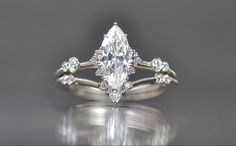 an engagement ring with a pear shaped diamond