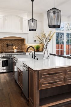 a kitchen with an island, sink and oven in it's centerpieces