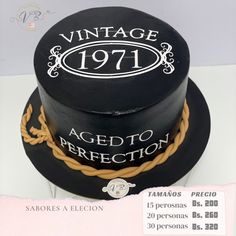 a black cake with white writing on the top and brown rope around the bottom that says vintage 1971 aged to perfection