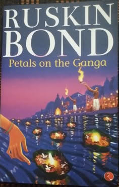 a book cover for petals on the ganga by ruskin bond with an image of hands holding lit candles