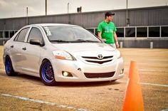 a man standing next to a white car