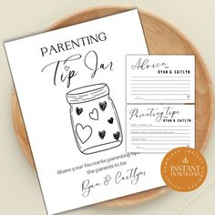 a printable baby shower card with a jar and hearts on it, next to a wooden