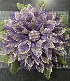 a purple and white flower sitting on top of a cutting board