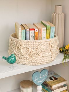 a book shelf with books on it and a basket full of books sitting on top