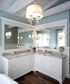 a large bathroom with two sinks and a chandelier